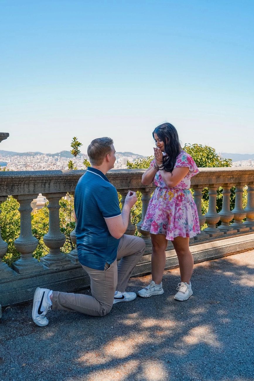 Daniel proposing to Allison on a terrace overlooking Barcelona